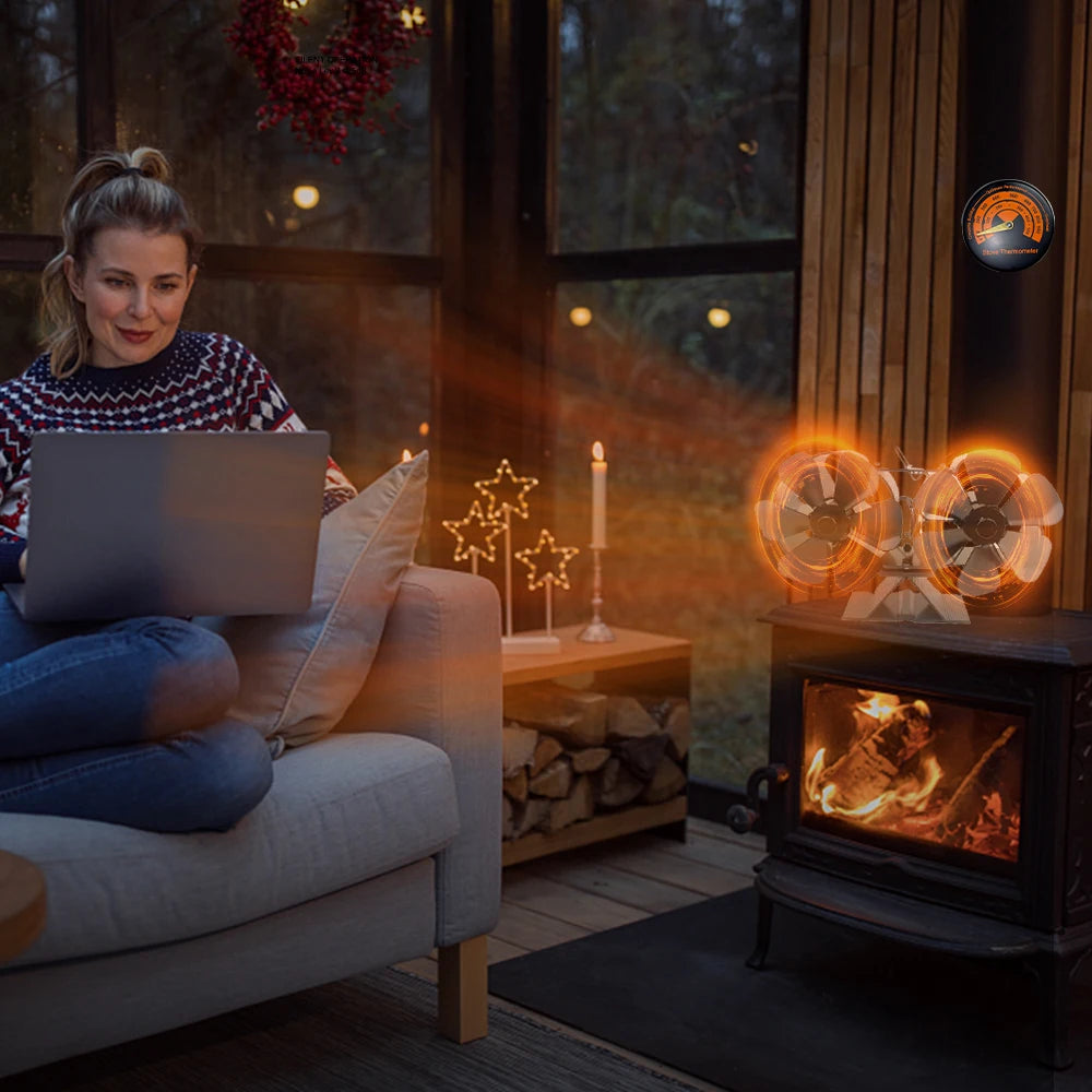 Woman using a laptop on a couch in a cozy room with a fireplace and decorative lights.