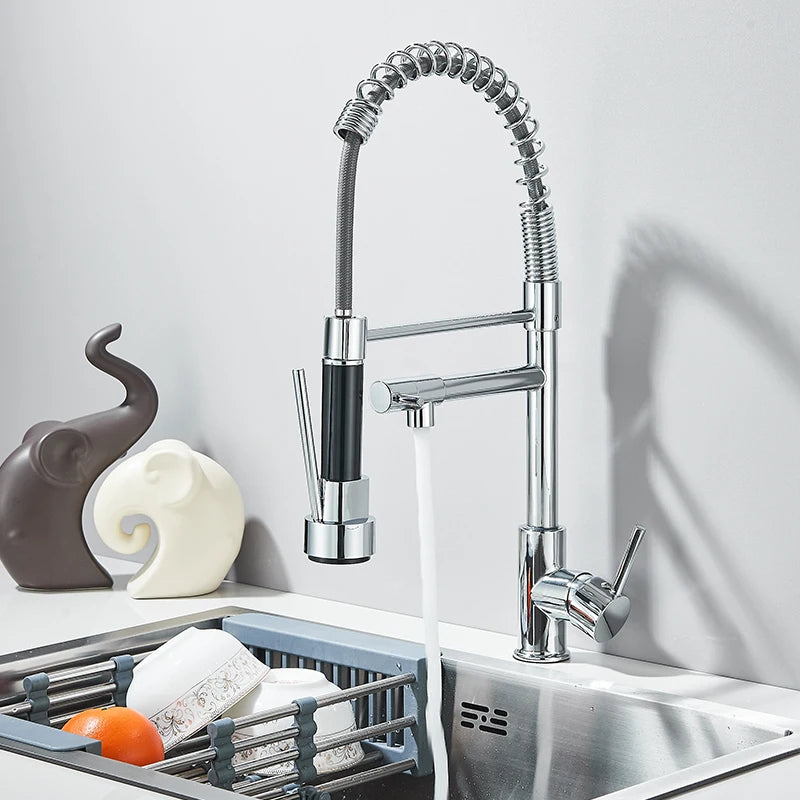 Modern kitchen faucet with a pull-down sprayer over a sink.