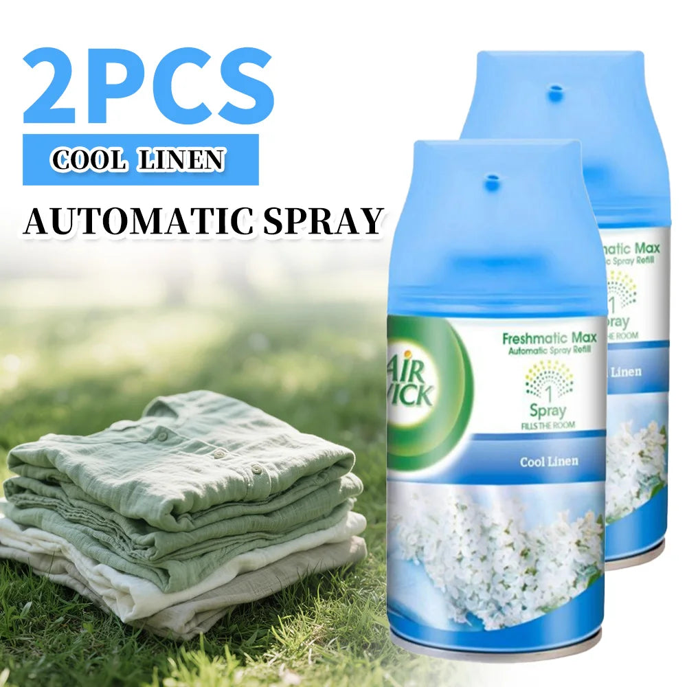 Two Air Wick Cool Linen automatic spray bottles with a stack of green linen on grass.