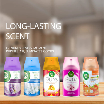 Five Air Wick air freshener bottles on a wooden surface with a blurred room background.