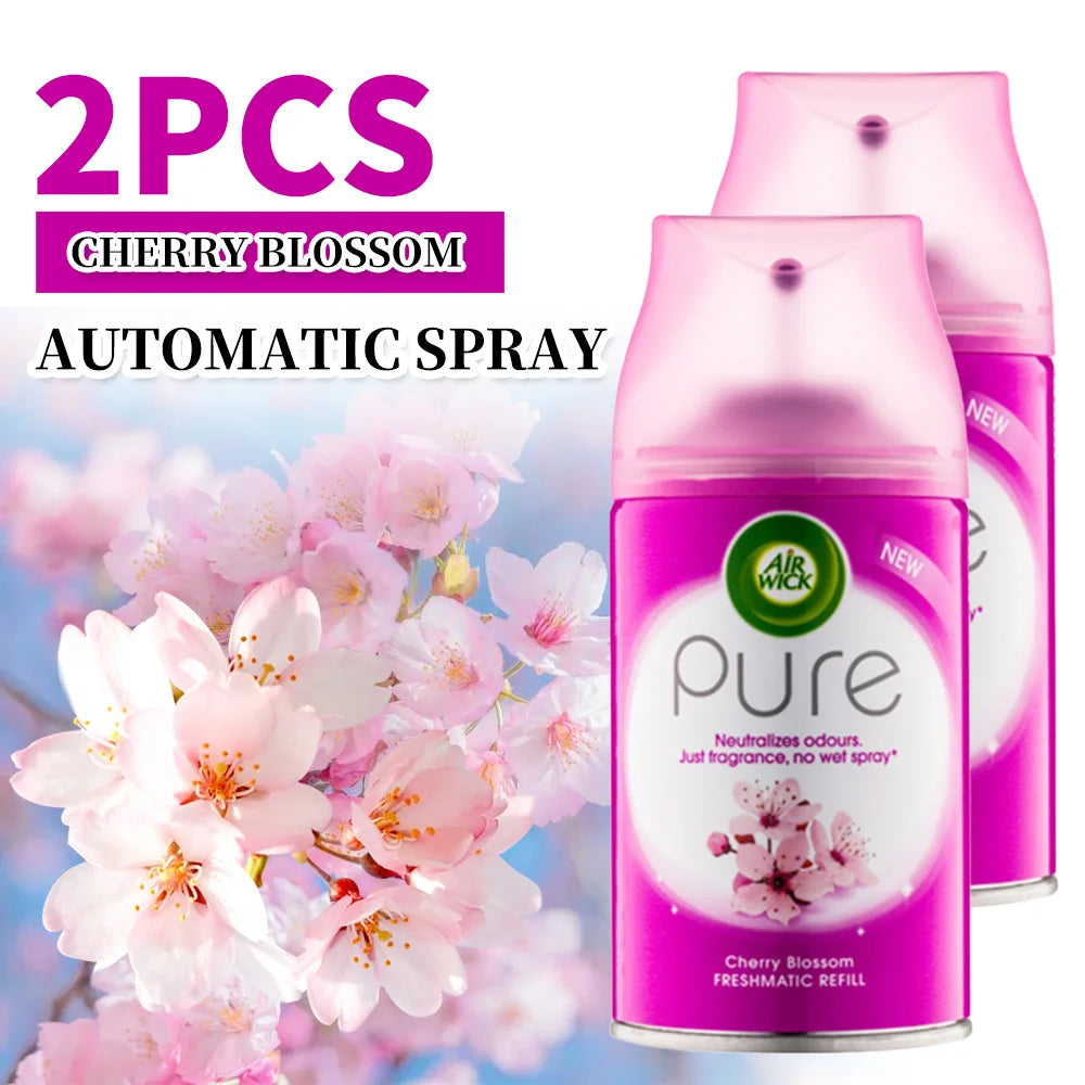 Two Air Wick Pure Cherry Blossom automatic spray refills with cherry blossom flowers in the background.